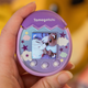 A photo of the Tamagotchi Pix with a camera preview on the screen instead of the Tamagotch interface